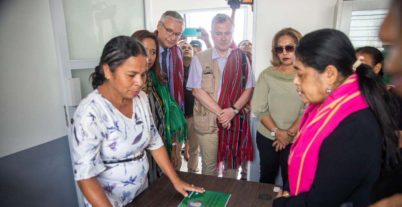 Women and men looking at documents on a desk