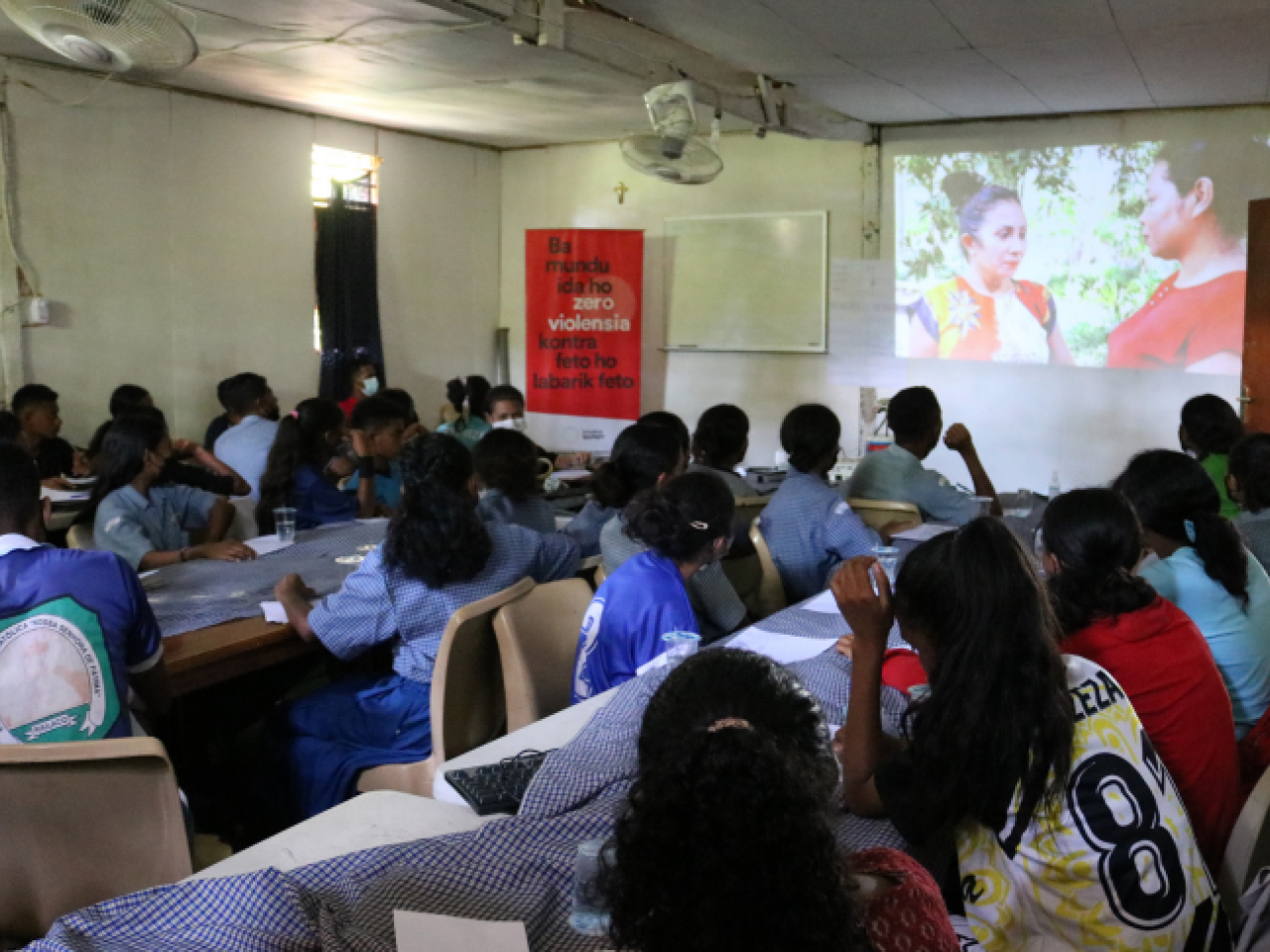 Young people watch a film screening in a class room