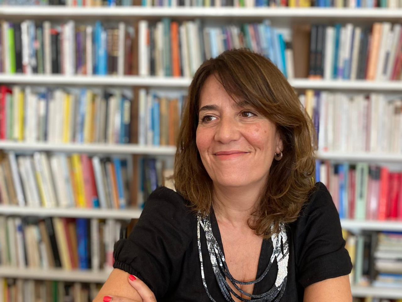 Smiling woman in front of book case