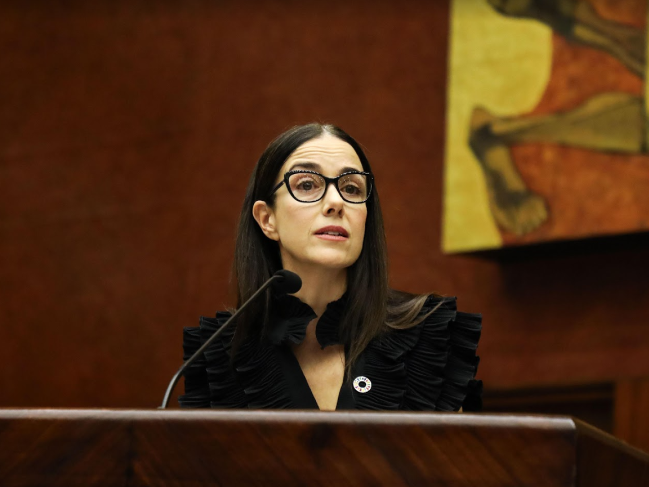 Ms Suarez stands at a lectern