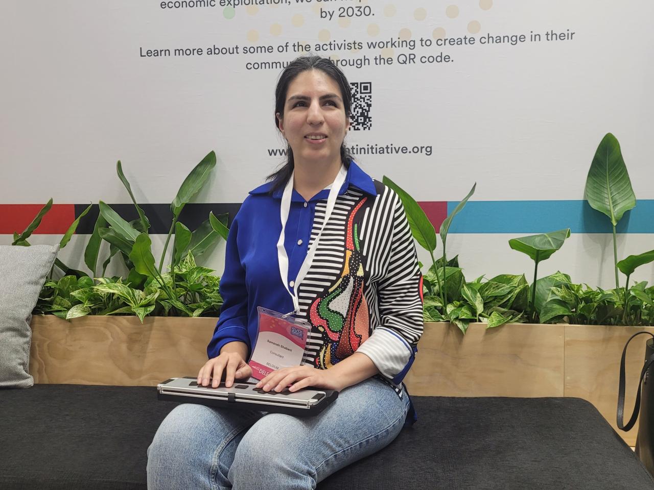 Samaneh Shabani seated in front of plants at SVRI