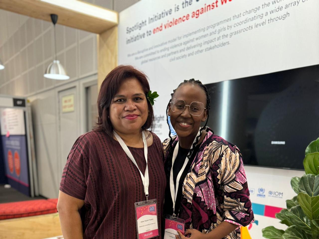 Two women wearing lanyards