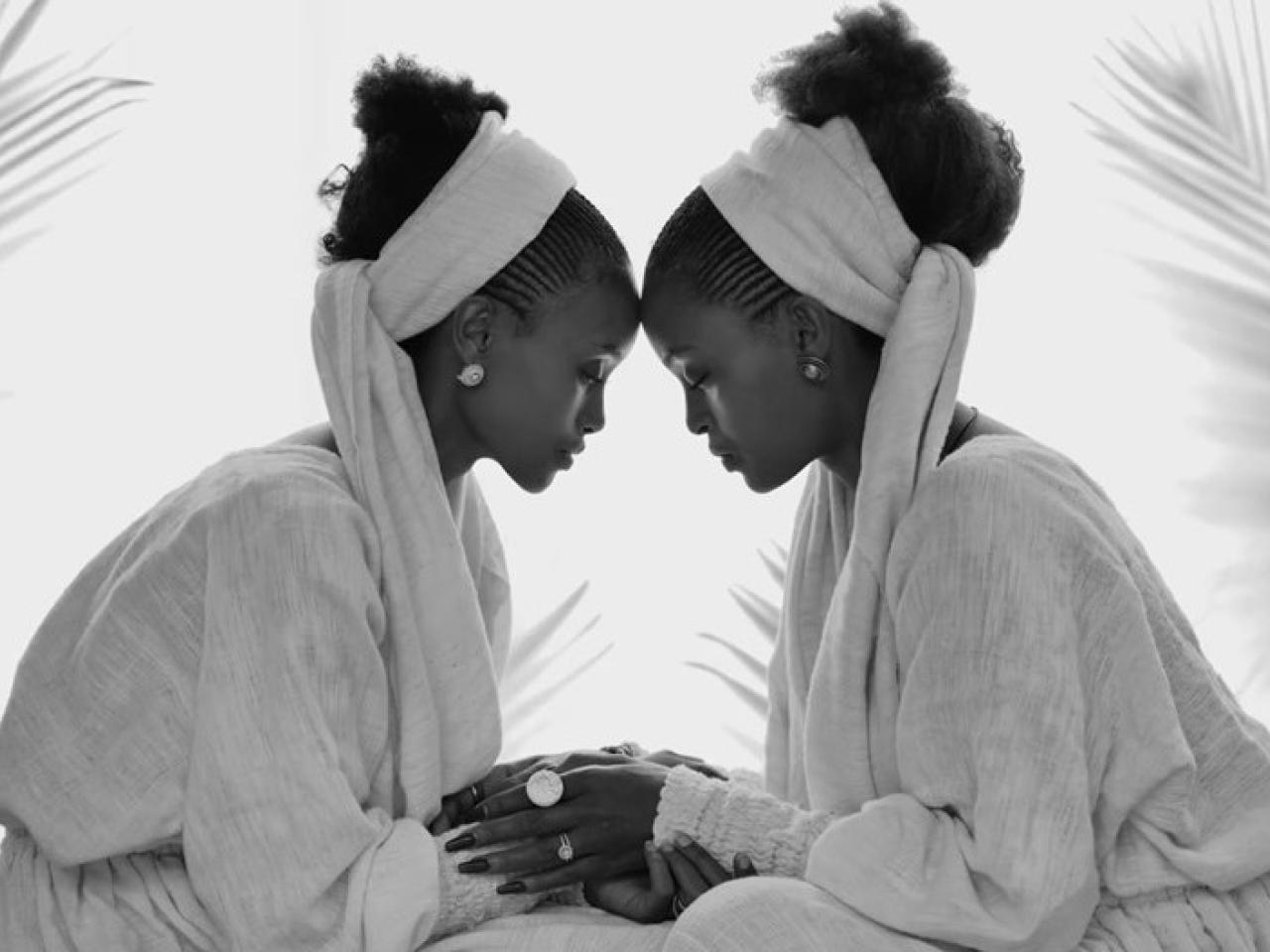 Two women with foreheads against one another