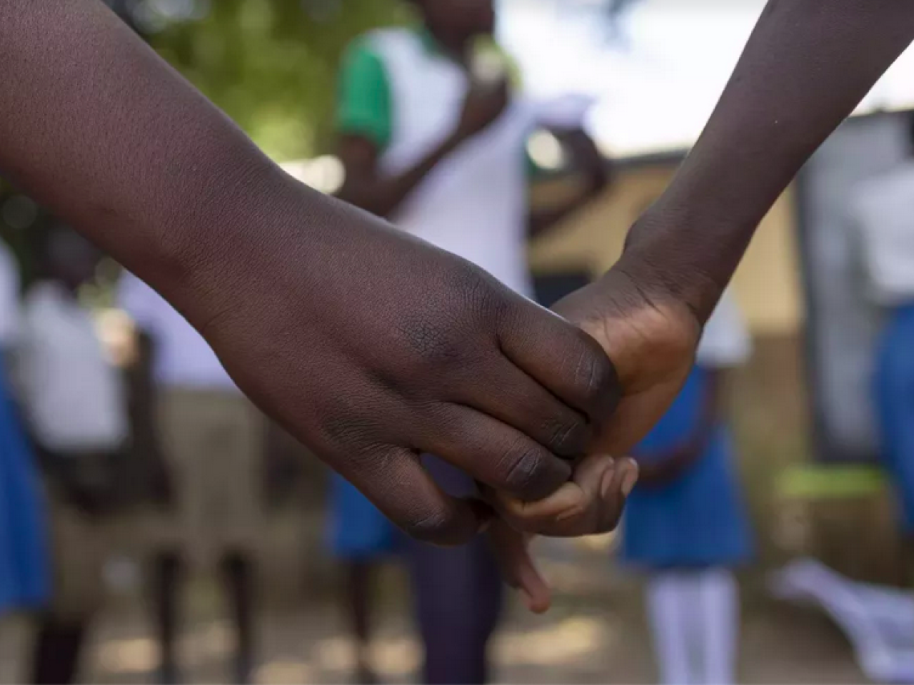 close up of girls in uniform holding hands
