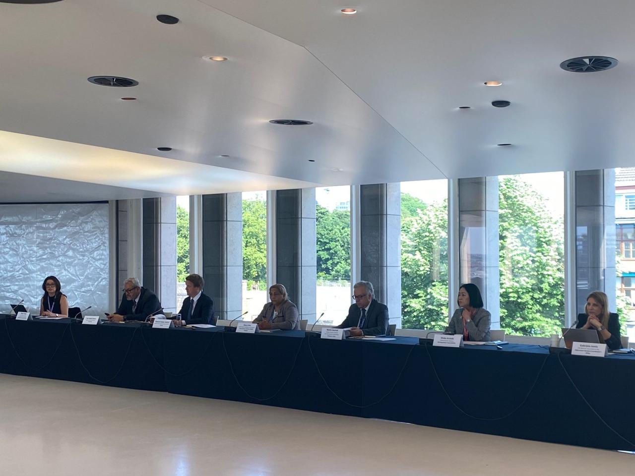 Speakers seated at table