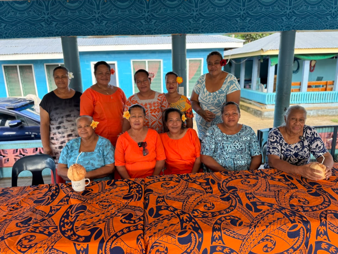 Ten women seated in a fale