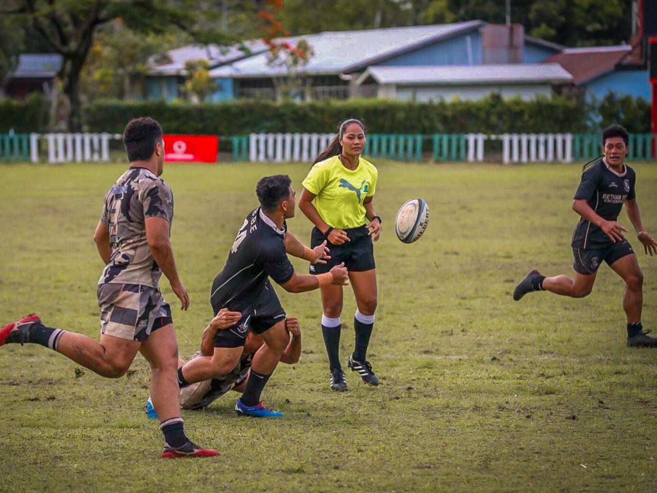 Avi'i Fa'alupega on the field refereeing a match