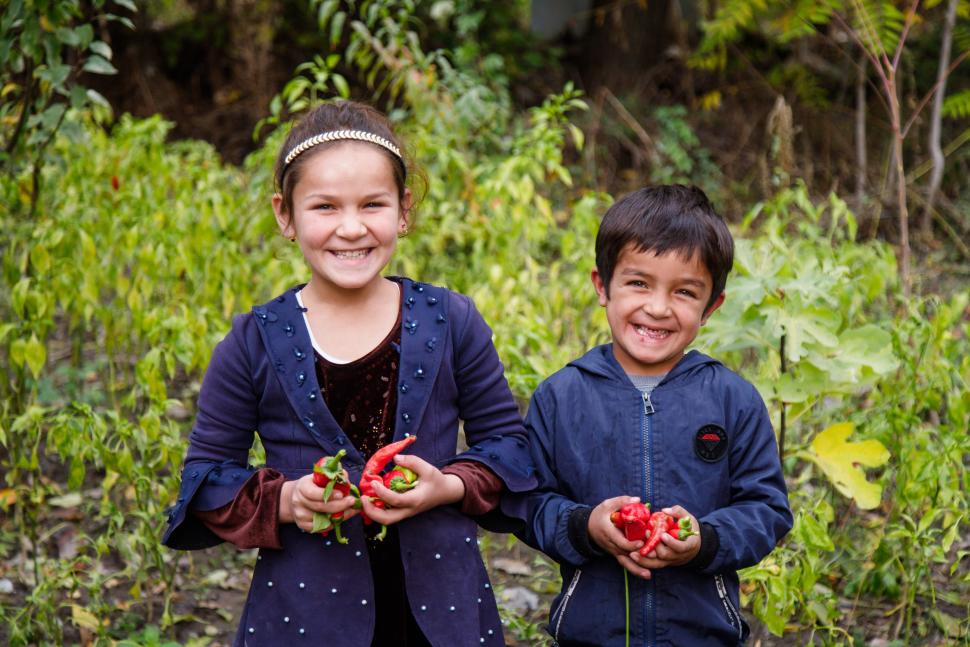 Two children holding produce