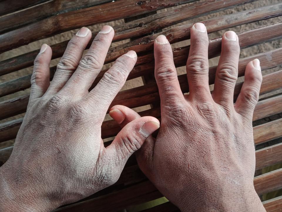 Men's hands covered in dust