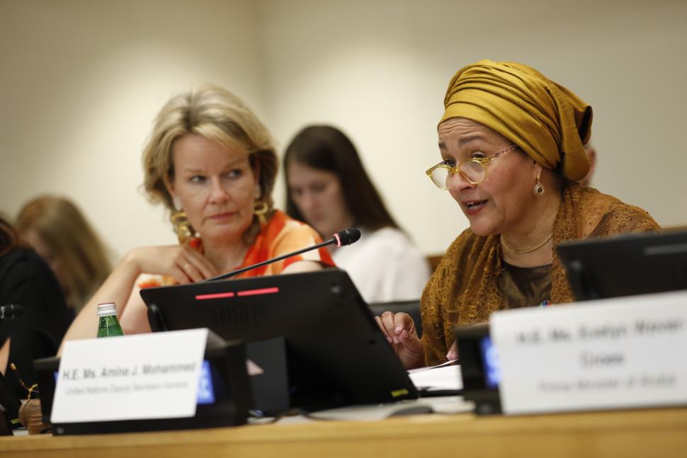 UN Deputy Secretary General seated beside Queens of the Belgians