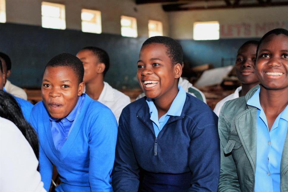 Girls in school uniforms laughing in the classroom 