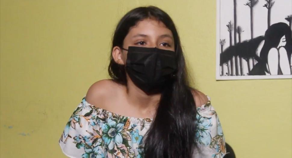 A girl wearing a mask in floral top
