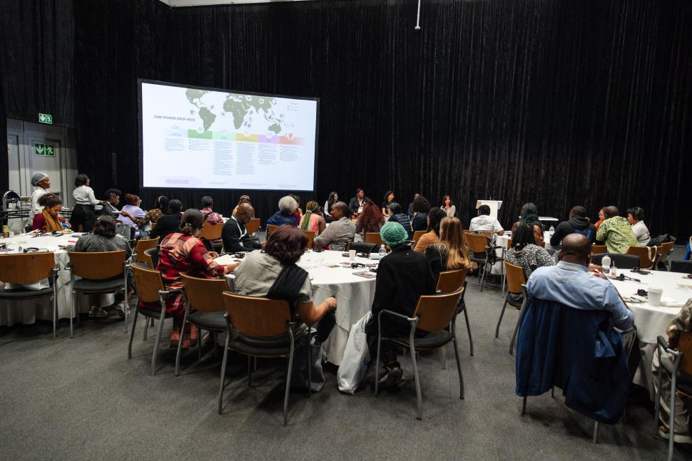 Wide shot of people seated at round tables