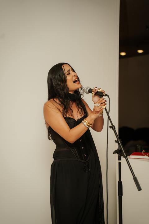 Woman singing into mic