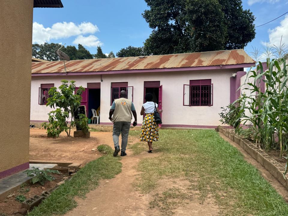 Man and a woman photographed from behind walking towards a building