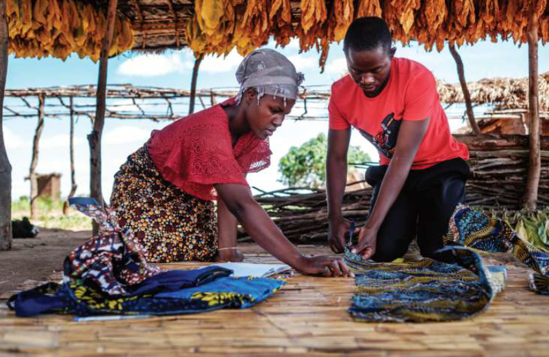 Alfonsina and her husband prepare some cloth for sewing