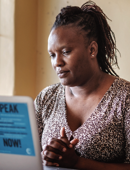 Priscah sits at a laptop