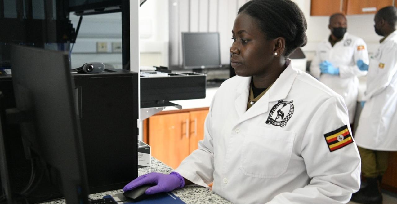 A woman in lab coat looking at computer