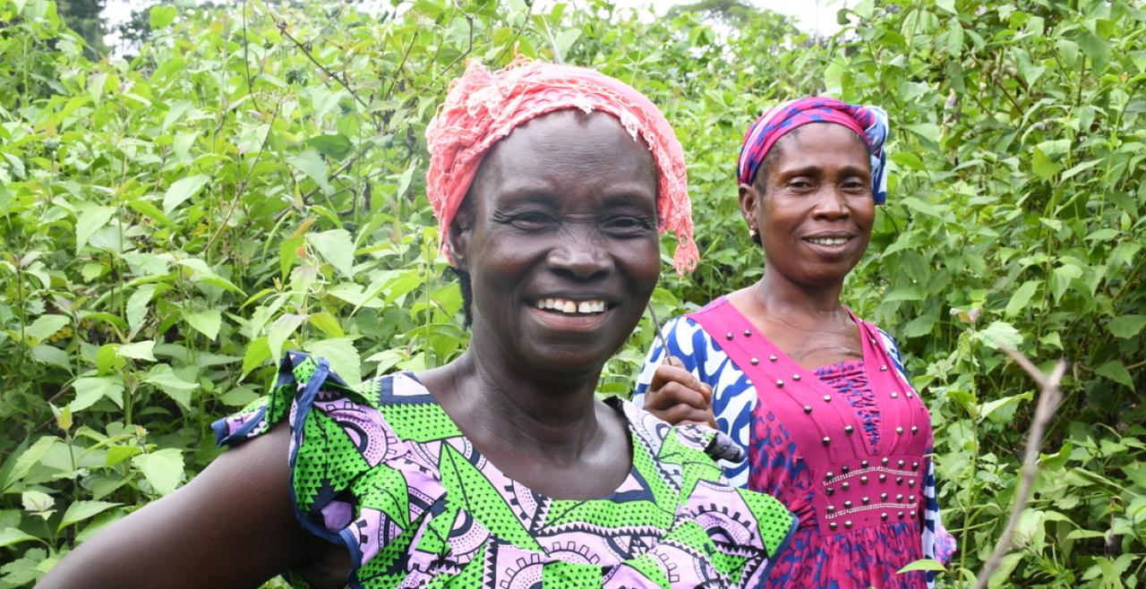 Two women smiling among their crops