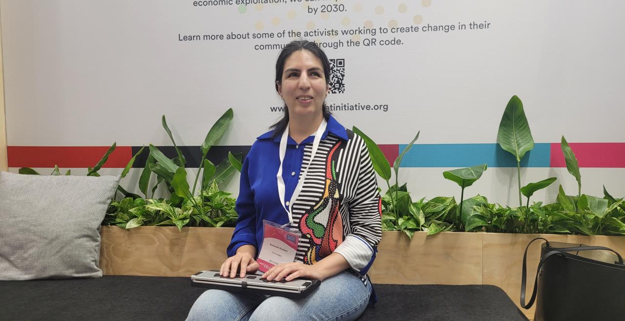 Samaneh Shabani seated in front of plants at SVRI