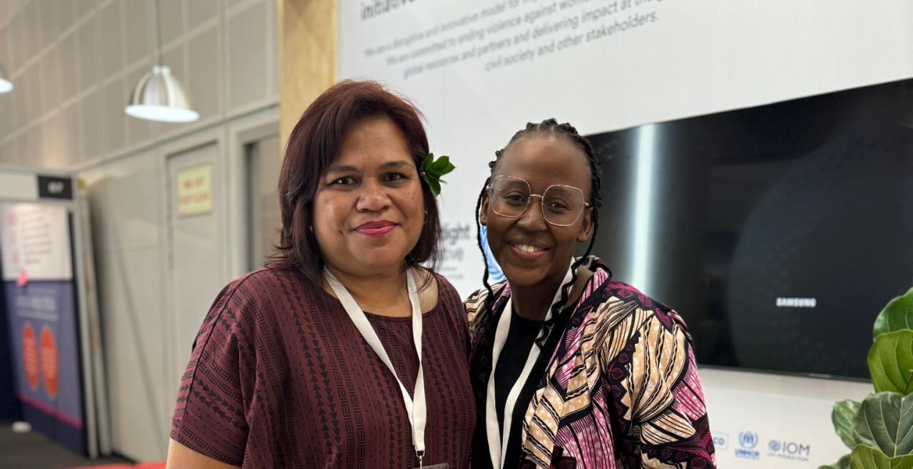 Two women wearing lanyards