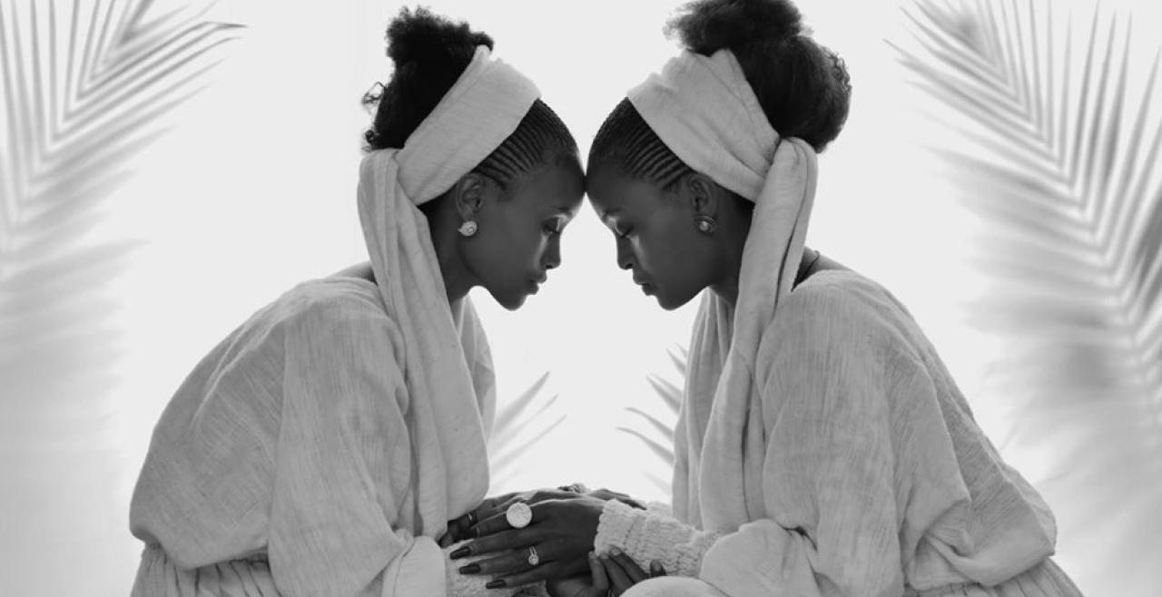 Two women with foreheads against one another