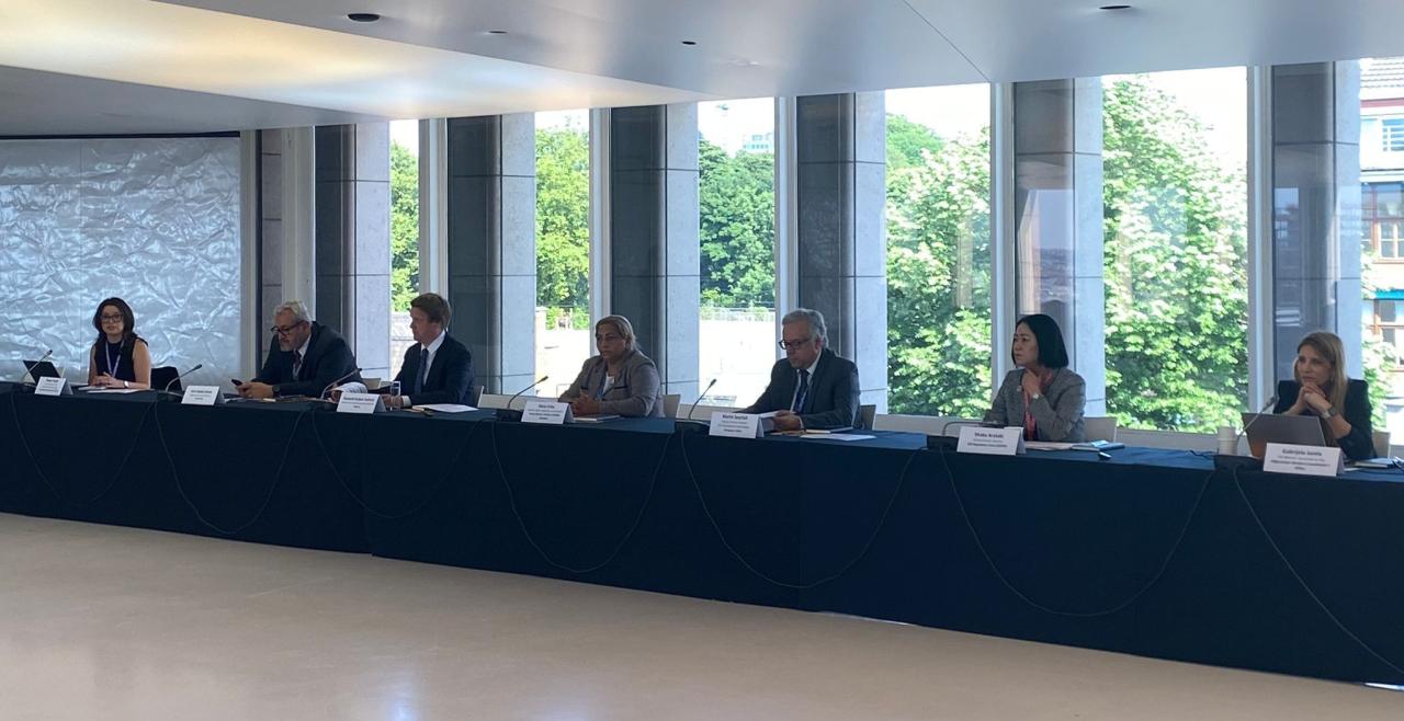Speakers seated at table