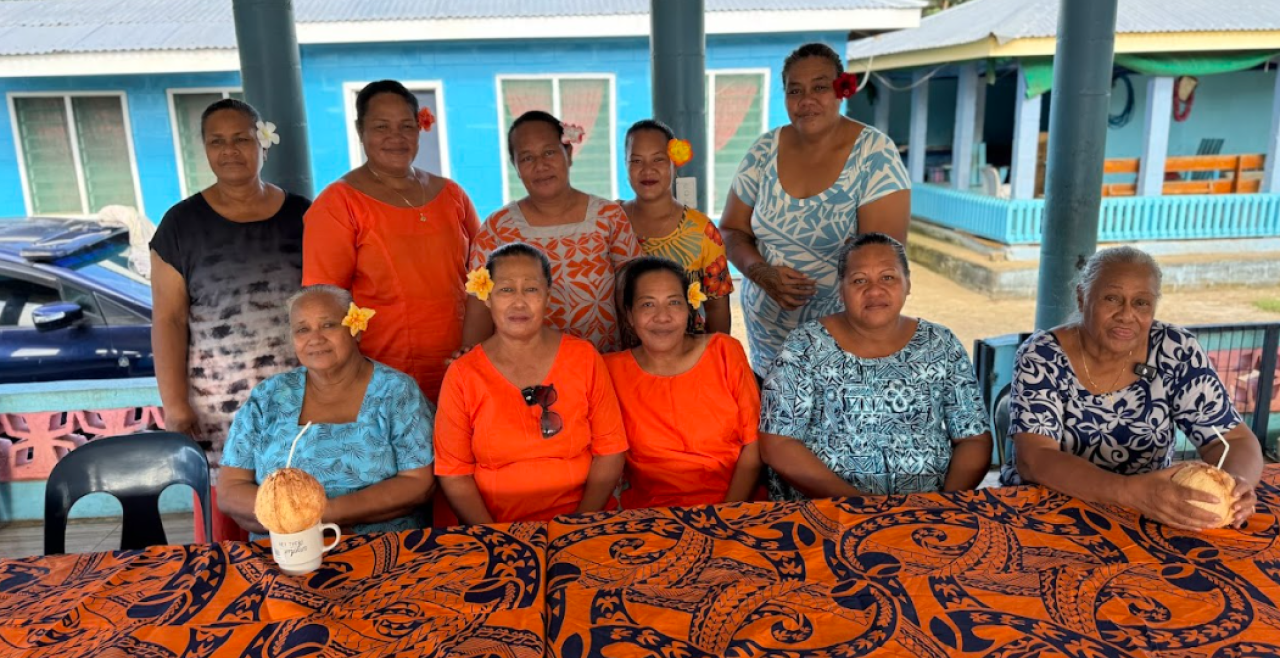 Ten women seated in a fale