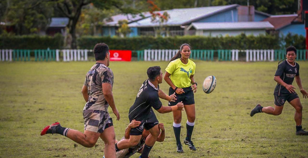 Avi'i Fa'alupega on the field refereeing a match