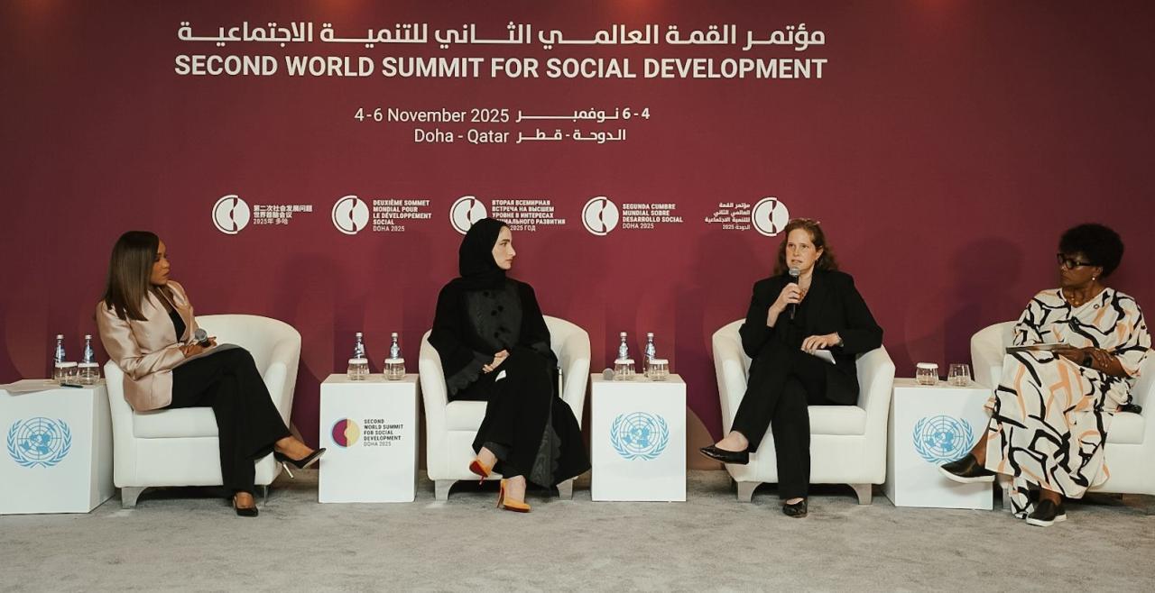 Panel of four women seated on stage