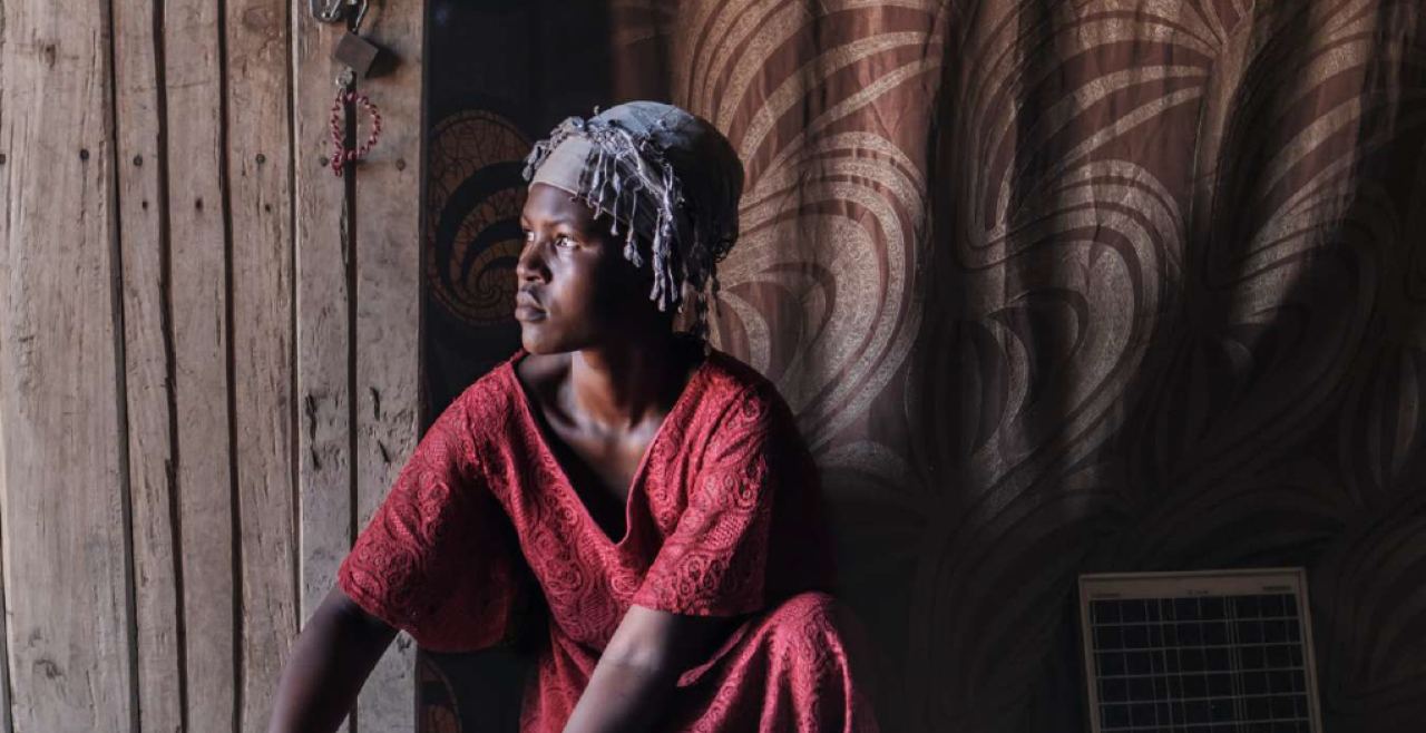 A woman in a doorway wearing a red dress