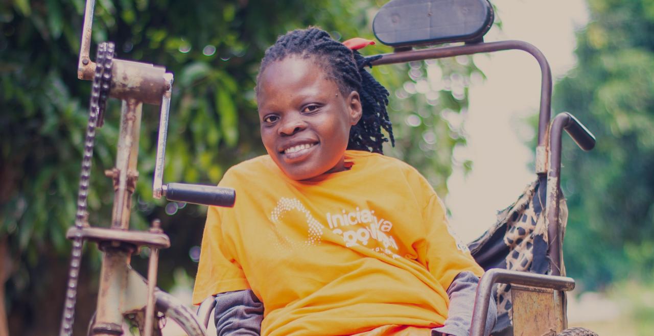 Smiling woman in orange t-shirt in wheelchair