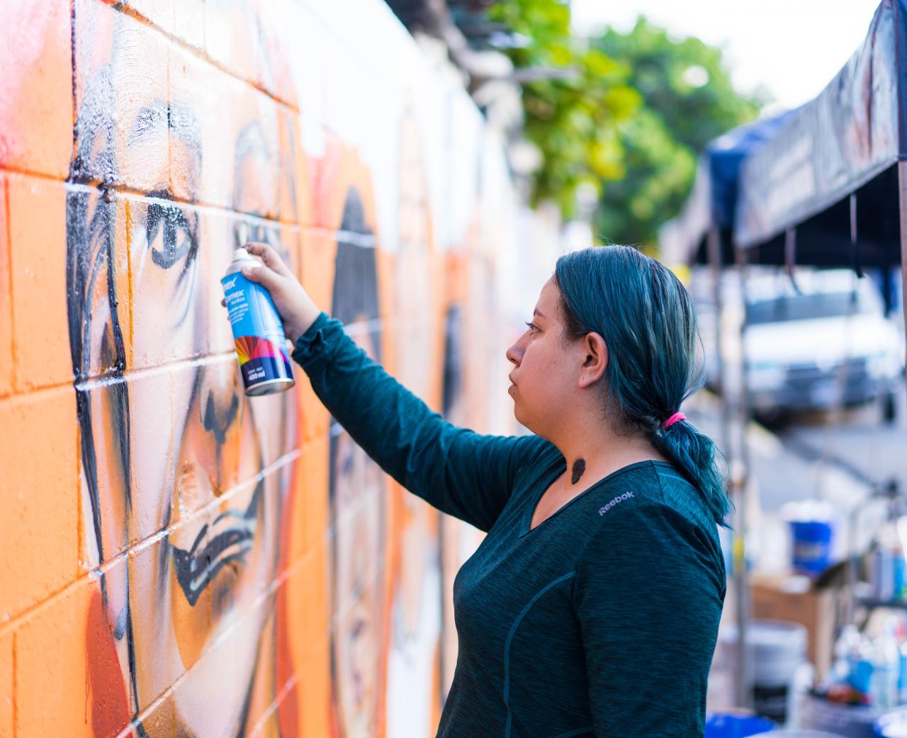 Woman creating mural
